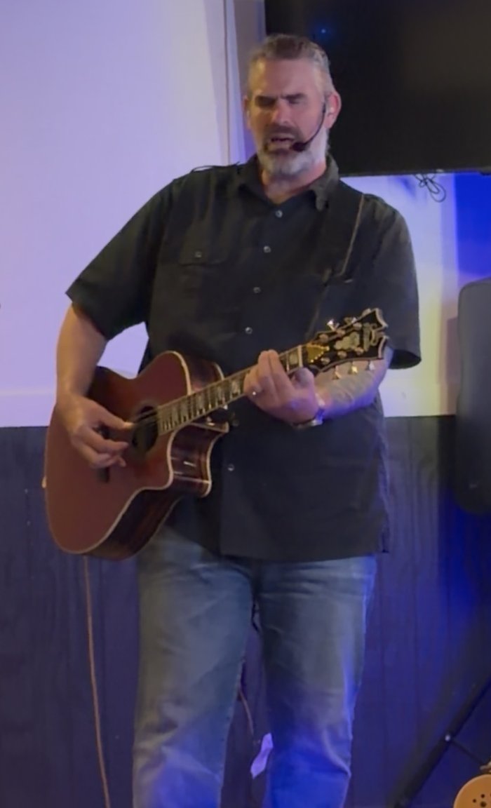 Randy Bennett performing live with an acoustic guitar